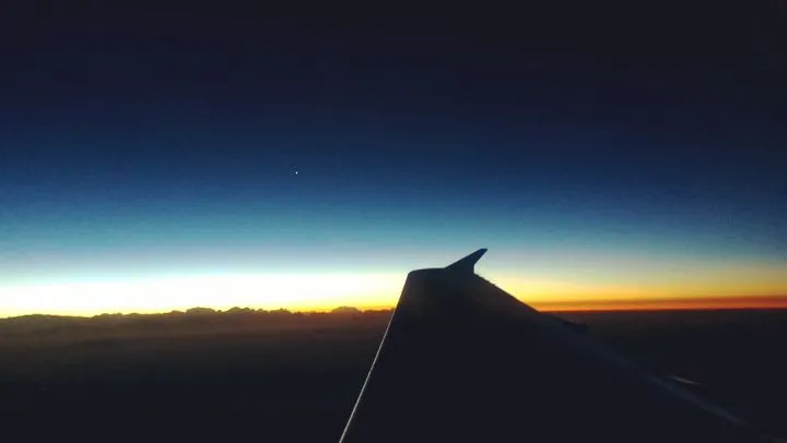 A photograph of a sunrise captured from an aeroplane window.