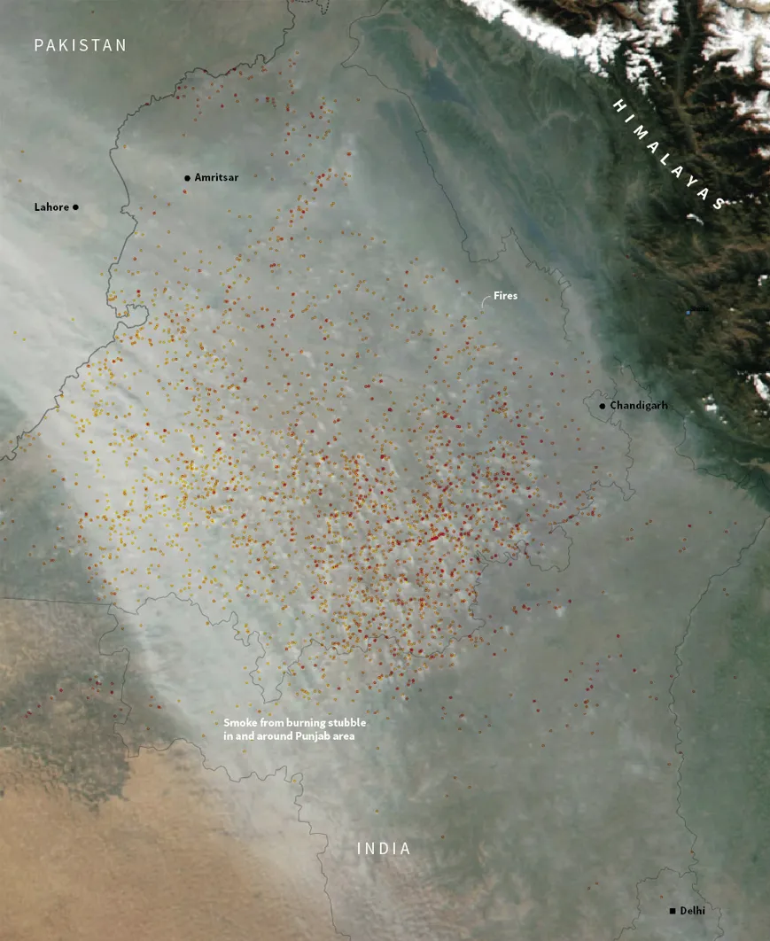 A satellite image showing Punjab, Haryana and Delhi covered by a white smoky haze. Red dots are overlaid on it to show location of stubble burning fires detected by satellite.