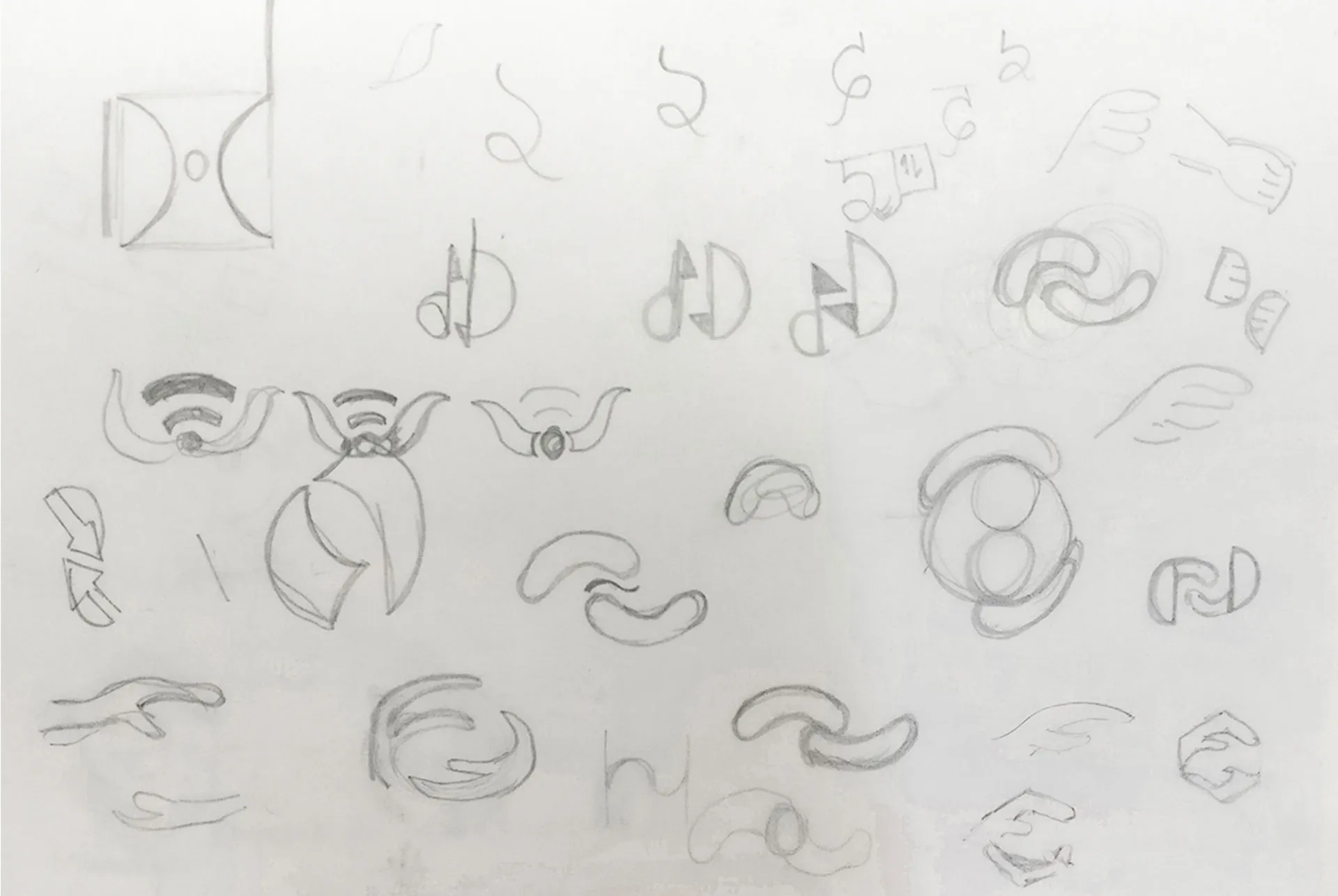 Photo of pencil sketches on paper showing logo ideas